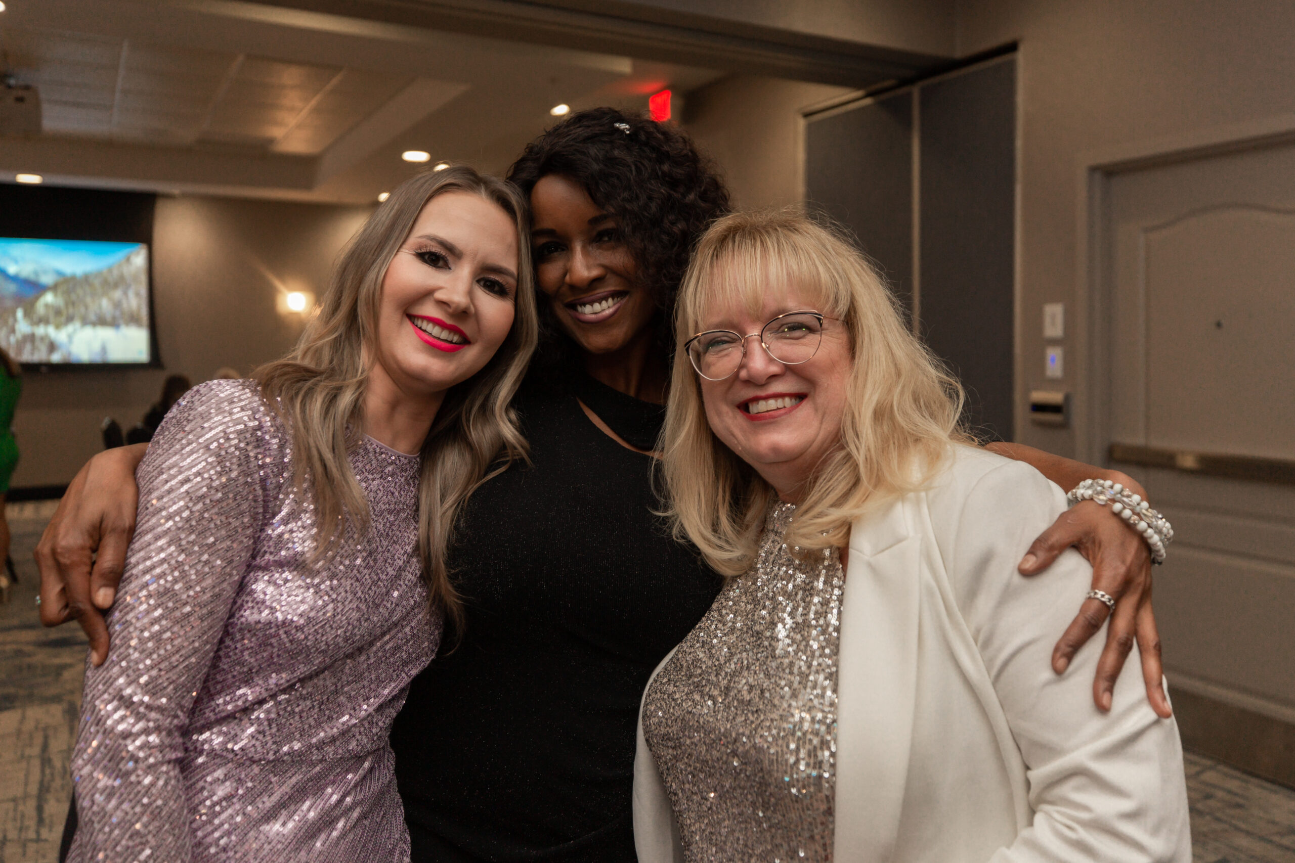 Group hug of this incredible team, Realtor Nadya Lopes, Director of Public Relations and Accountant Lisa Bradford