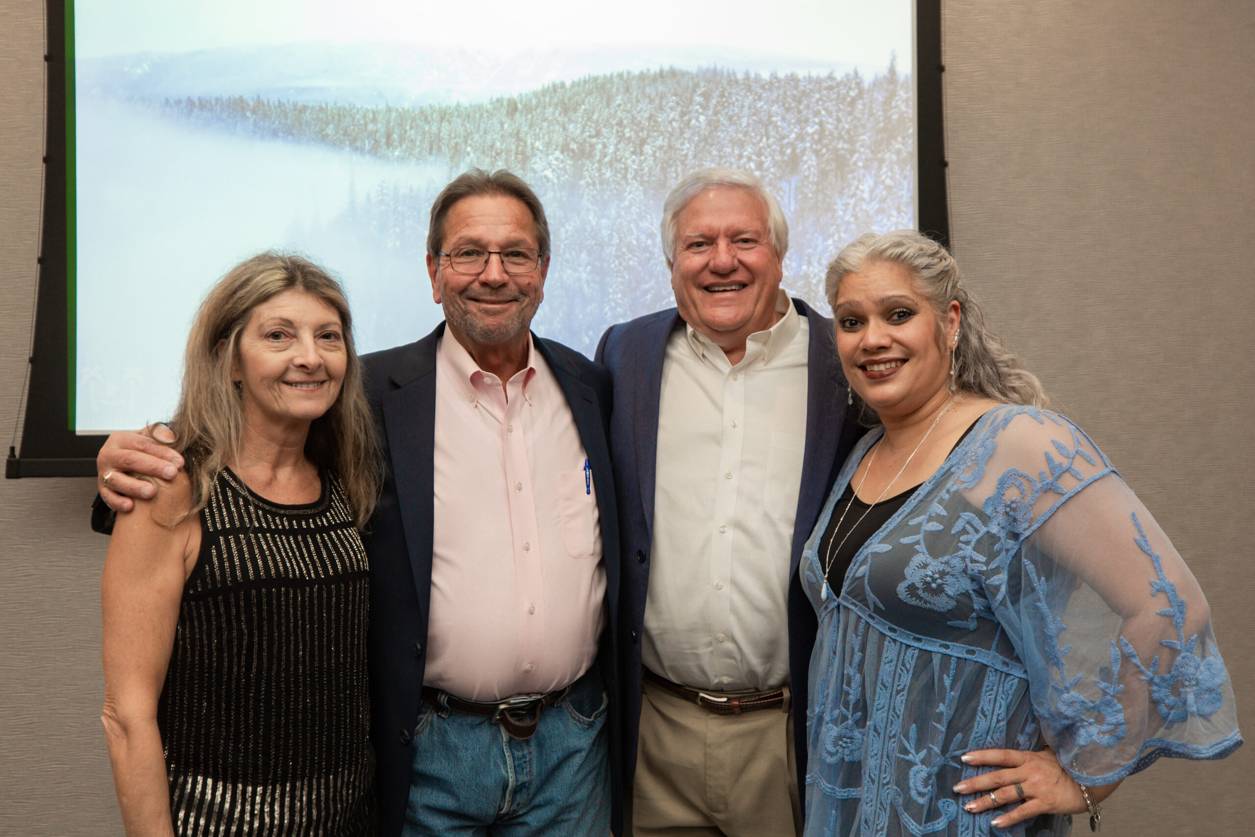 Waterford Oaks team group hug. From left to right, Accountant Lynne Jessup, Supervisor Robert Palmer, Vice-President John Jobson and Property Manager and Realtor Lisa Melendez