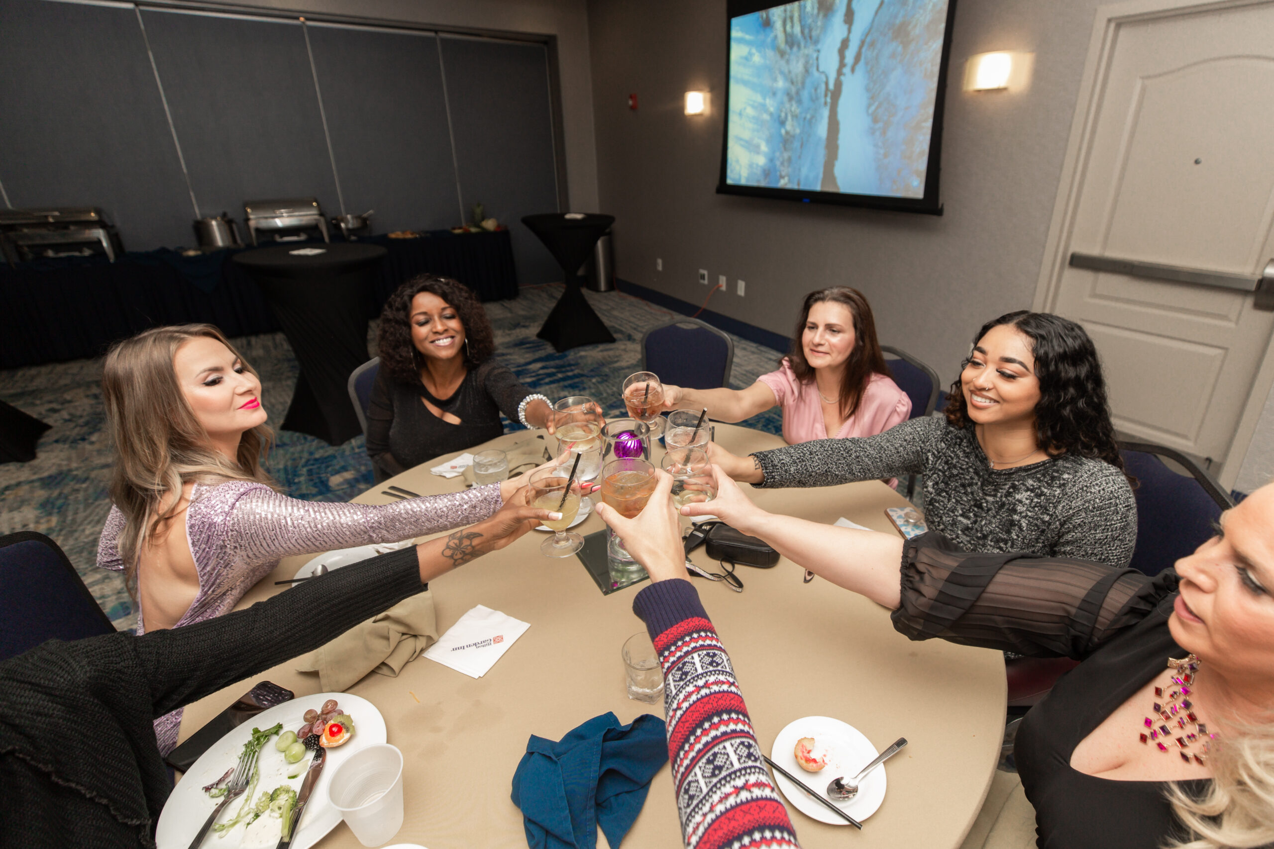 Cheers! Realtors Nadya Lopes, Rita Hegedus, Kayla Weatherspoon, Director of Public Relations Latoya Grayson and Director of Sales Jennifer Hamilton sharing a festive toast.